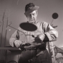 Publicity photograph for Pierre Matisse of Calder in his storefront studio, New York, 1936